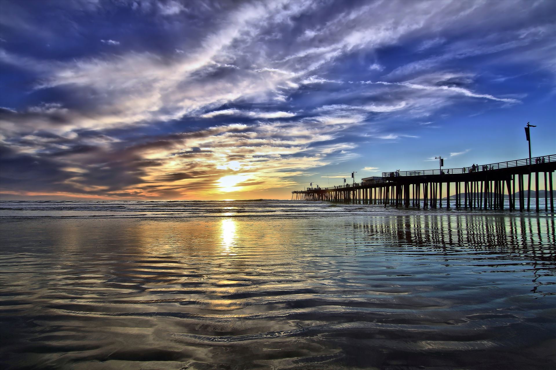 Pismo Pier Sunset Reflections of the Pismo Beach Pier on a silvery beach. by Emotions Photography