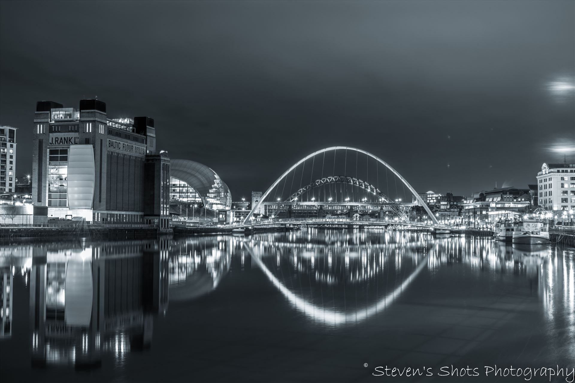Millennium Bridge and Tyne Bridge A black and white picture of the Millennium Bridge and Tyne Bridge on Newcastle quayside, the Baltic is visible also. by Steven's Shots Photography