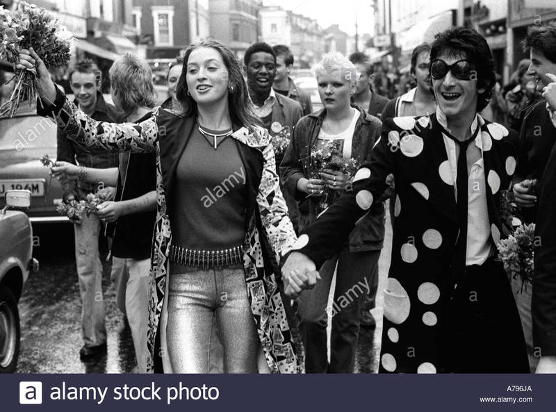 punks-hand-out-flowers-to-passing-car-drivers-as-they-walk-down-the-A796JA_zps2hffdgpo.jpg  by Arthur Pringle