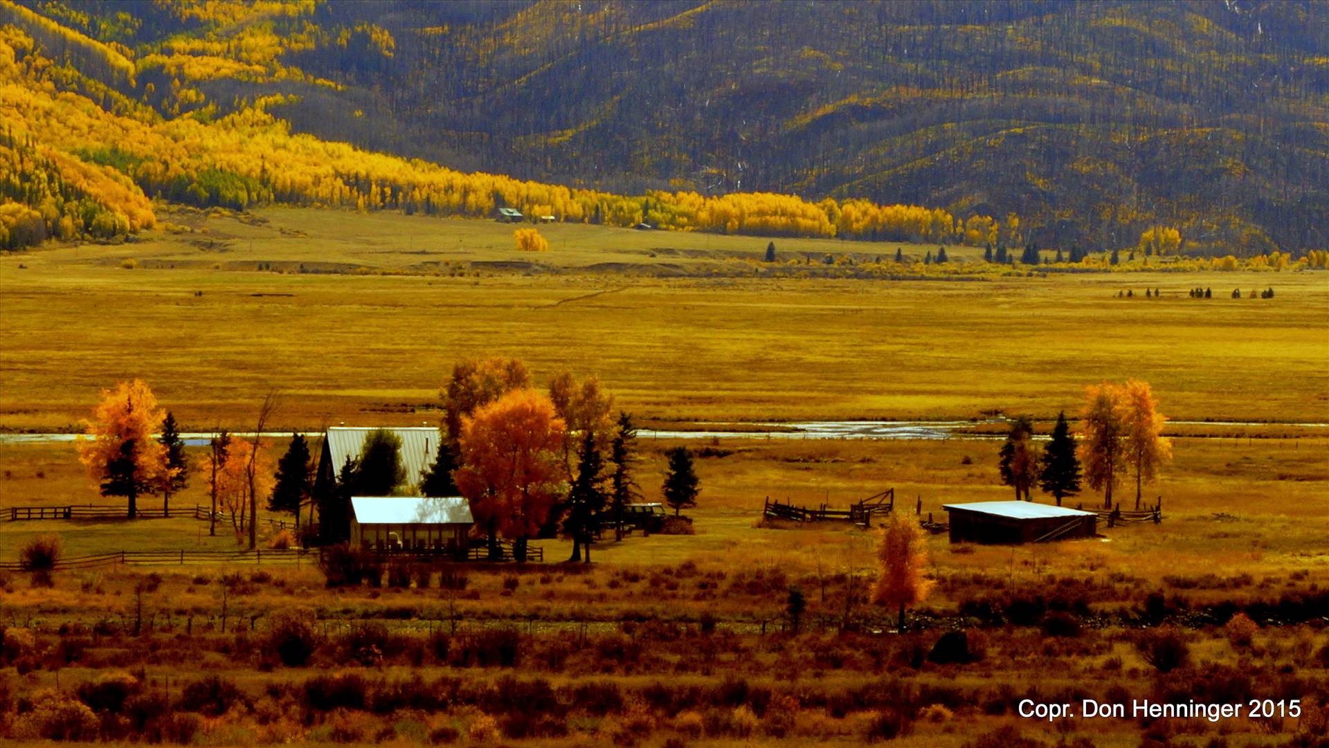 On Golden Ranch Solitary ranch near Creede, Colorado, nestled in a valley along Rio Grande headwaters amid golden and yellow autumn colors of high prairie grasses and aspens. by WPC-360