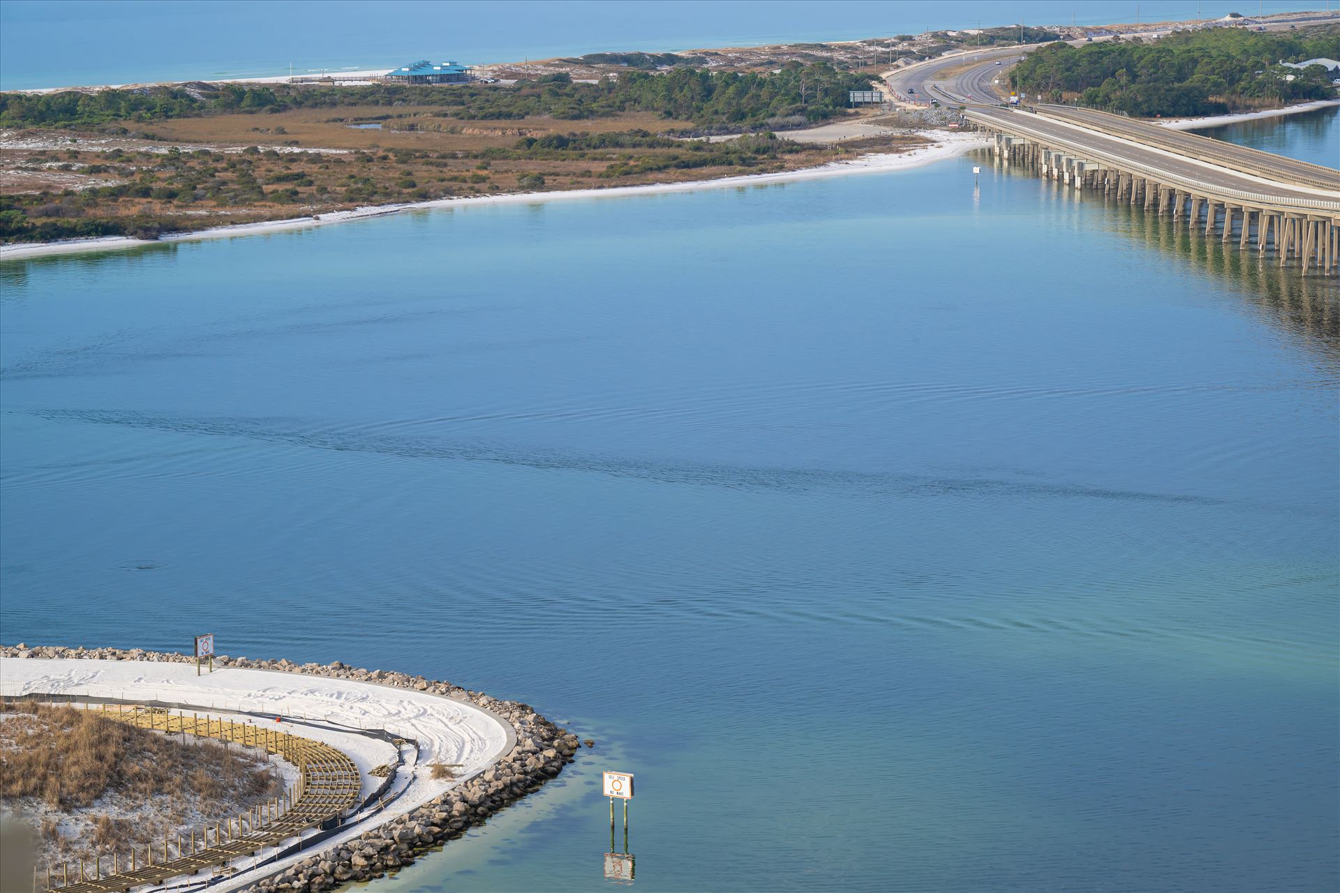 Destin, Florida, where the bridge stretches over crystal-clear water Destin, Florida, where the bridge stretches over crystal-clear waters, leading to pristine white sand beaches under the warm coastal sun. by Terry Kelly Photography