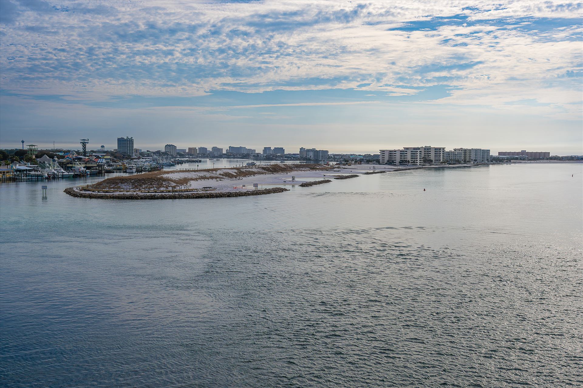 Destin Harbor Florida USA Destin Harbor Florida USA shines under a brilliant blue sky, with fluffy clouds reflecting on the emerald-green waters, creating a picture-perfect coastal scene. by Terry Kelly Photography