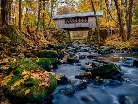 Vibrant fall colors decorate the Tannery Hill Covered Bridge in Gilford, New Hampshire by New England Photography