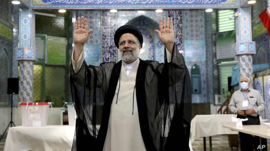 APTOPIX Iran Elections Ebrahim Raisi a candidate in Iran's presidential elections waves to the media after casting his vote at a polling station in Tehran, Iran Friday, June 18, 2021. Iran began voting Friday in a presidential election tipped in the favor of a hard-line protege by mohsen dehbashi