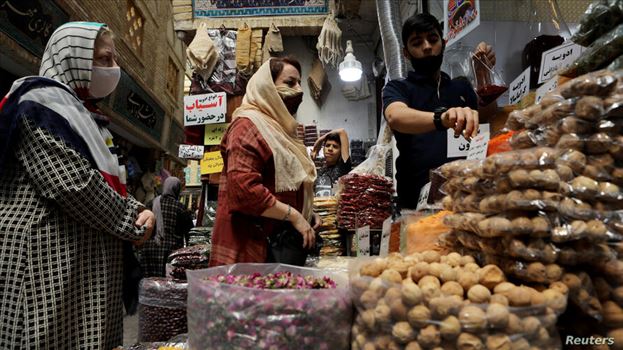 Women wearing protective face masks shop at a bazaar following the outbreak of the coronavirus disease (COVID-19), in Tehran, Iran, July 8, 2020. WANA by mohsen dehbashi