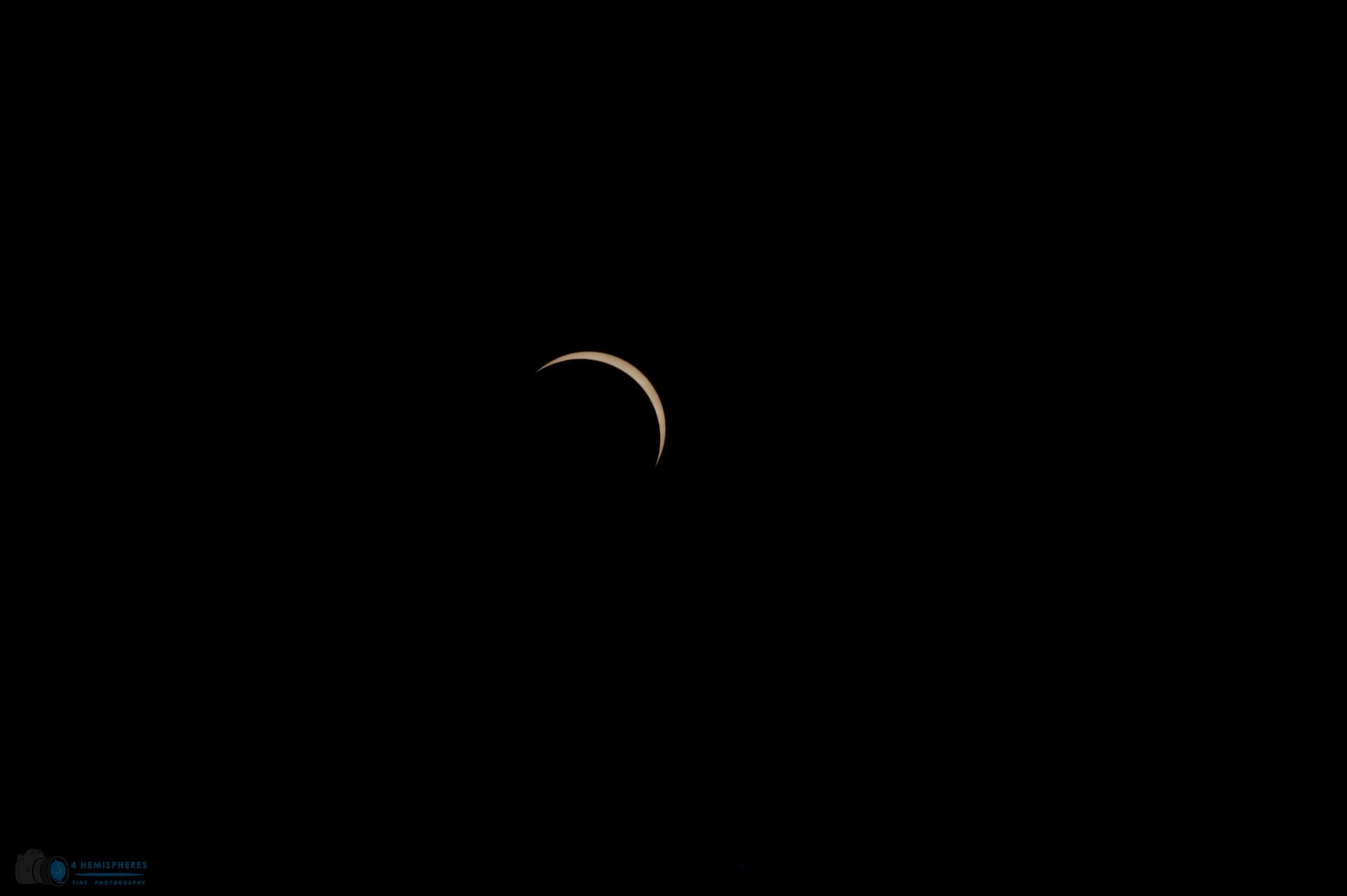 Last Crescent Sun continues to come out of total coverage by moon. by 4 Hemispheres Photography