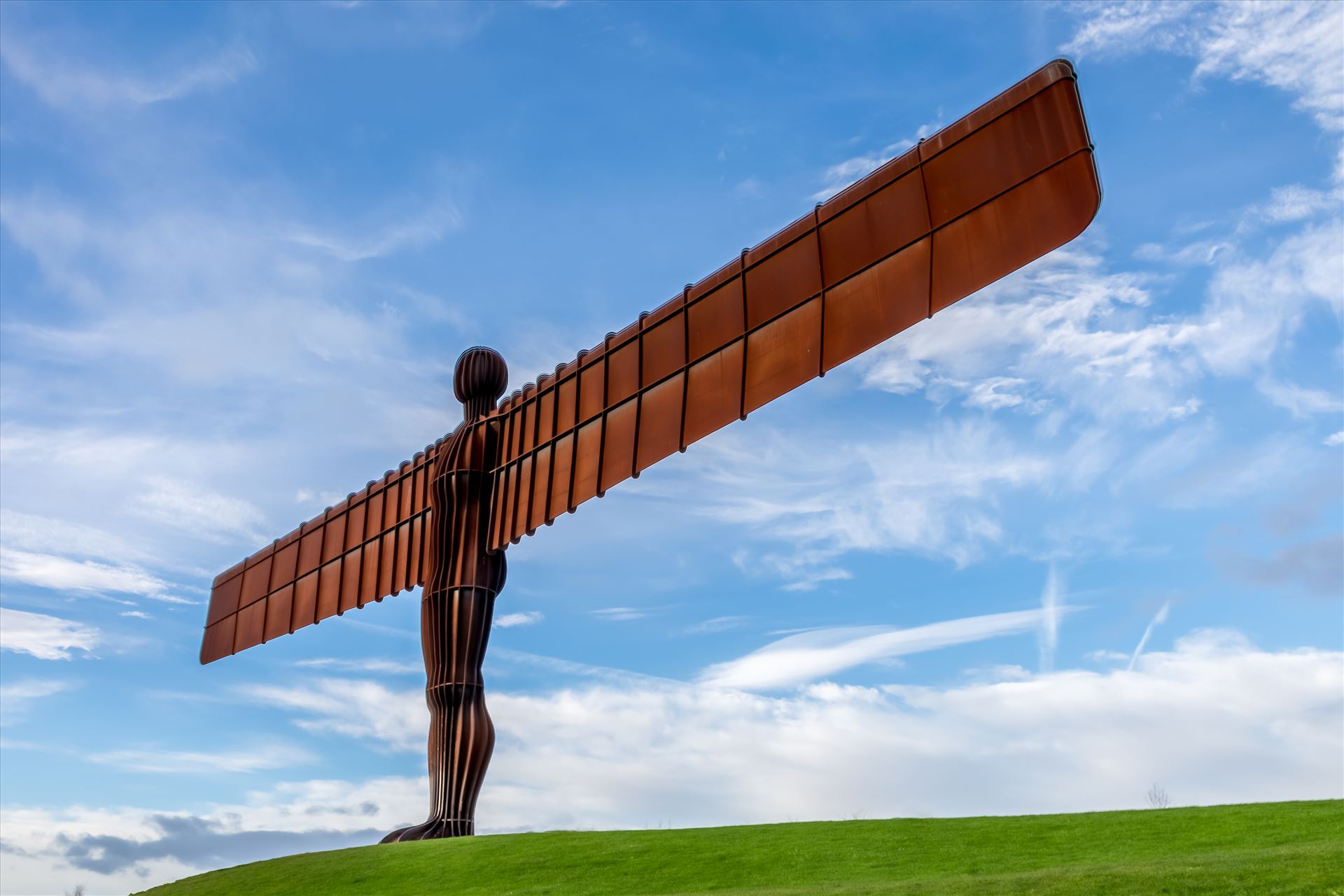 The Angel of the North The Angel of the North is a contemporary sculpture, designed by Antony Gormley, located in Gateshead,  England.Completed in 1998, it is a steel sculpture of an angel, 20 metres (66 ft) tall, with wings measuring 54 metres (177 ft) across. by philreay