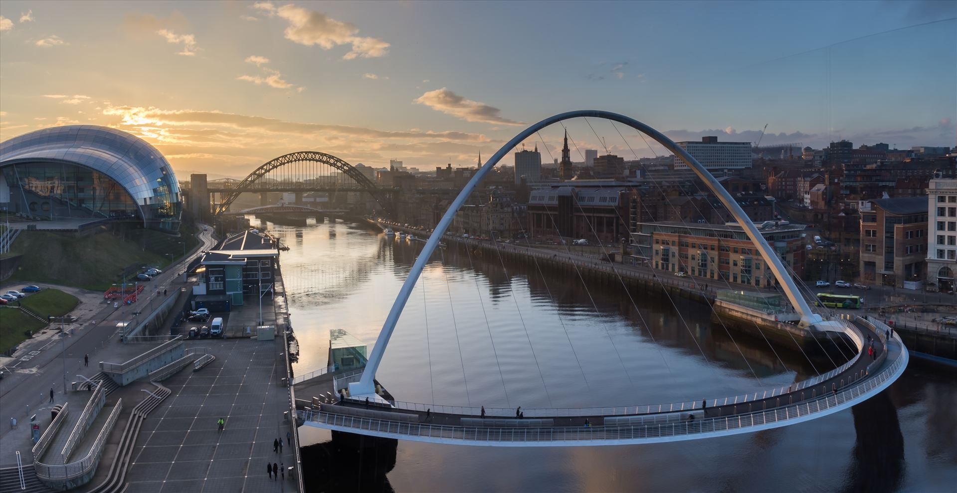 Gateshead & Newcastle quaysides at sunset Taken from the viewing platform on level 4 of the Baltic arts building. This photo is made from 3 separate images stitched together to make this panoramic shot. by philreay