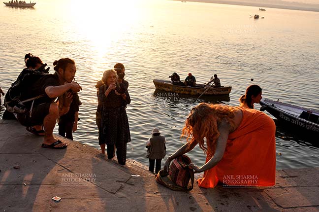 Travel- Varanasi the city of light (India) A foreign devotee after taking bath in Holy River Ganges at Varanasi, Uttar Pradesh, India. by Anil