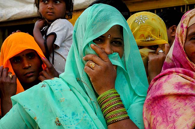 Festivals- Lathmaar Holi of Barsana (India) A local women covering her face with her saree at Barsana, Mathura, Uttar Pradesh, India. by Anil