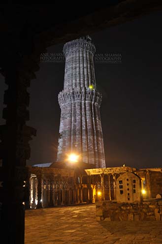 Monuments- Qutab Minar in Night, New Delhi, India. Qutub Minar Complex in night at Mehrauli Archaeological Park, New Delhi, India. by Anil