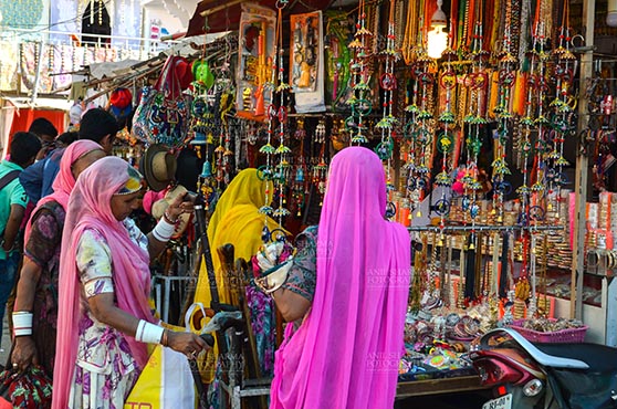 Fairs- Pushkar Fair, Rajasthan, India. (Photo: Anil Sharma) Pushkar, Rajasthan, India- January 16, 2018:  Rajasthani ladies shopping at a shop during Pushkar Fair, Rajasthan, India. by Anil