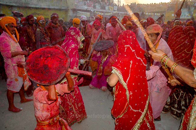 Festivals- Lathmaar Holi of Barsana (India) A man from Nandgaon protecting himself from womens of Barsana hitting on his shield with their sticks during Lathmaar Holi at Barsana. by Anil