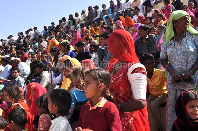 Festivals- Jaisalmer Desert Festival, Rajasthan Local people enjoying women's matkaa race at Jaisalmer desert fair. by Anil