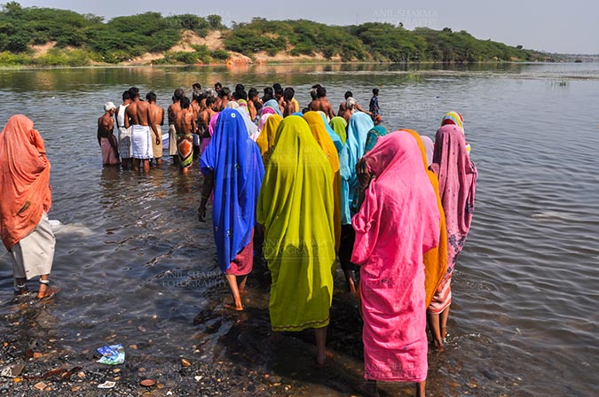 Fairs- Baneshwar Tribal Fair Baneshwar, Dungarpur, Rajasthan, India- February 14, 2011: Devotees ready for the traditional ritual bath at the confluence of the rivers, Mahi and Som at Baneshwar, Dungarpur, Rajasthan, India. by Anil