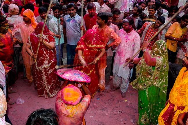 Festivals- Lathmaar Holi of Barsana (India) A man from Nandgaon protecting himself from womens of Barsana hitting on his shield with their sticks during Lathmaar Holi at Barsana. by Anil
