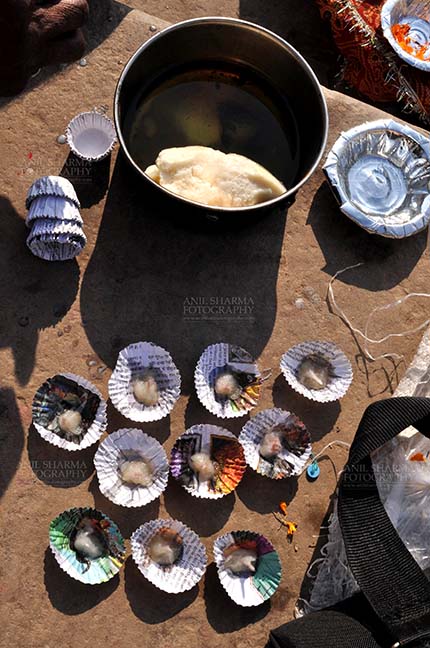 Travel- Varanasi the city of light (India) Cow butter on paper plates for puja. by Anil