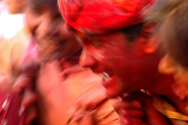 Festivals- Lathmaar Holi of Barsana (India) A man daubed in colored powder smiles as he celebrates “Lathmaar Holi”at Mathura, Uttar Pradesh, India. by Anil