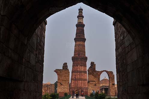 Monuments- Qutab Minar, New Delhi, India. Qutab Minar, minaret tower with verses from Holy Quran at Qutab Minar Complex, New Delhi, India. by Anil