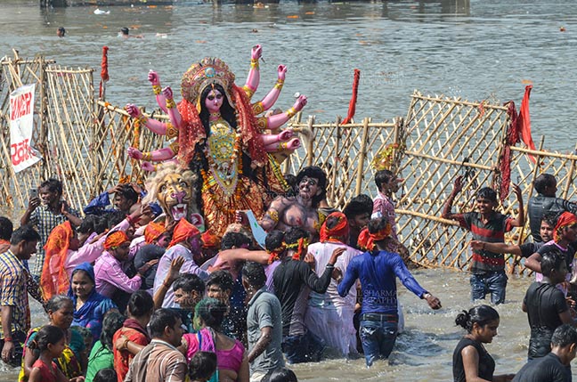 Festivals- Durga Puja Festival Durga Puja Festival, New Delhi, India-September 30, 2017: The Idol of Goddess Durga before the final immersion into the river Yamuna at Kalindi Kunj, New Delhi, India. by Anil