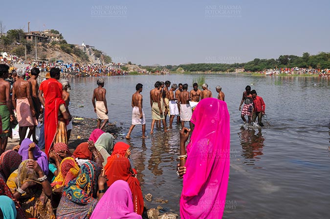 Fairs- Baneshwar Tribal Fair, Dungarpur, Rajasthan, India. (Photo: Atul Sharma) Baneshwar, Dungarpur, Rajasthan, India- Devotees ready for the traditional ritual bath at the confluence of the rivers, Mahi and Som at Baneshwar, Rajasthan, India. by Anil