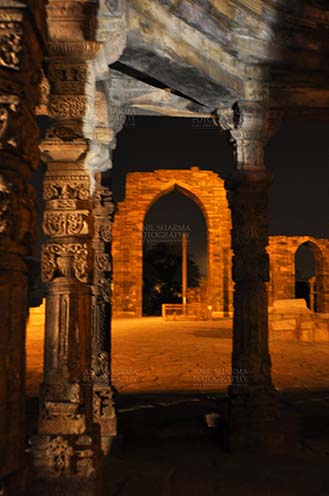 Monuments- Qutab Minar in Night, New Delhi, India. Qutab Minar, Mehrauli, New Delhi, India- October 25, 2010: Beauty of arches of  Iltutmish screen and iron pillar in night at Qutub Minar Complex, Mehrauli , New Delhi, India. by Anil