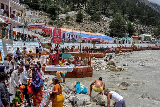 Travel- Gangotri (Uttarakhand) Gangotri, Uttarakhand, India- June 14, 2013: Devotees taking holy dip in ice cold water of Bhagirathi river at Gangotri, Uttarkashi, Uttarakhand, India. by Anil