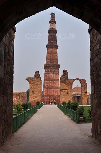 Monuments- Qutab Minar, New Delhi, India. Qutab Minar, minaret tower with verses from Holy Quran at Qutab Minar Complex, New Delhi, India. by Anil