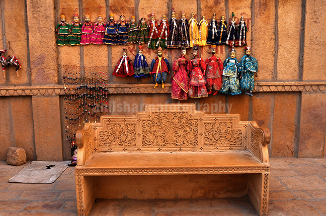 Festivals- Jaisalmer Desert Festival, Rajasthan Rajasthani Puppets hanging on the wall. by Anil