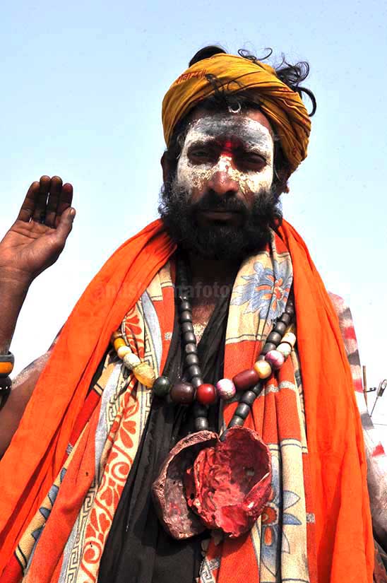 Culture- Aghori Sadhu, Uttar Pradesh (India). Aghori Sadhu with ash on the face, wearing human bones and  rudraksha bead at Mahakumbh Allahabad, Uttar Pradesh (India). by Anil