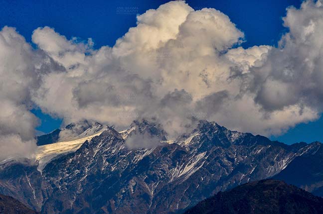 Clouds- Sky with Clouds (Panchchuli Peaks) Panchchuli Peaks, Munsiyari, Uttarakhand, India- November 2, 2016: Blue sky with bright white clouds over the snow covered Punchchuli Peaks view from Munsiyari, Uttarakhand, India. by Anil