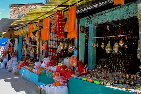 Travel- Gangotri (Uttarakhand) Gangotri, Uttarakhand, India- May 13, 2015: shopkeepers selling devotional objects, necklaces, beads, jewelry, gemstones, bracelets, earrings, bangles, and items for religious ceremonies at Gangotri, Uttarkashi, Uttarakhand, India. by Anil