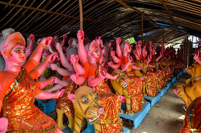 Festivals- Durga Puja Festival Durga Puja Festival, Noida, Uttar Pradesh, India- September 17, 2017: A row of Hindu Goddess Durga’s clay idol in a workshop in preparation for Durga Puja at Noida, Uttar Pradesh, India. by Anil