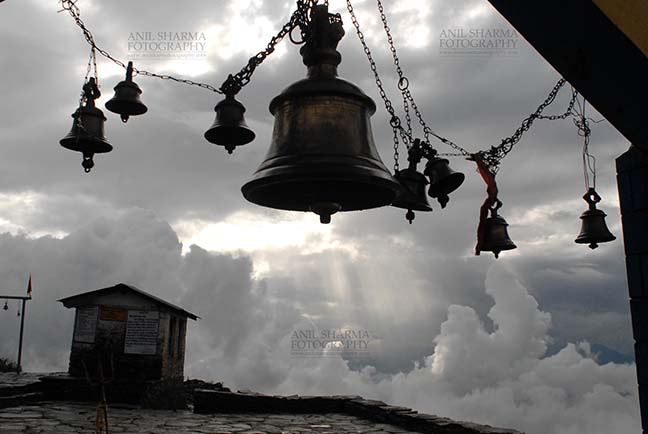 Religion- Tungnath Temple, Uttarakhand (India) Tungnath, Chopta, Uttarakhand, India- August 18, 2009: Temple bells, Sun and Clouds at at Tungnath, Chpota, Uttarakhand, India. by Anil