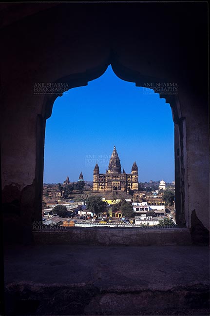 Monuments- Palaces and Temples of Orchha Orchha, Madhya Pradesh, India- May 14, 2008: View from a carved window of Jahangir Mahal, Chaturbhuj temple is seen in the distance, Orchha, Madhya Pradesh, India. by Anil