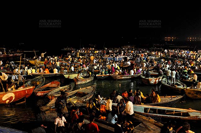 Travel- Varanasi the city of light (India) Large number of devotees in boats admiring aarti at Dasashwamedh Ghats in late evening at Varanasi. Uttar Pradesh, India. by Anil