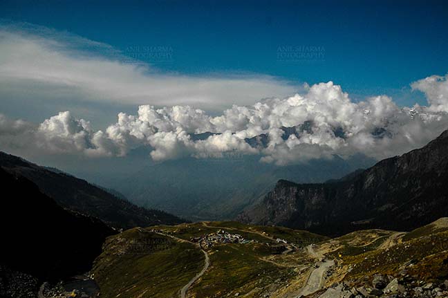 Clouds- Sky with Clouds (Rohtang La) Clouds over Rohtan La, Himachal Pradesh, India-September 22, 2009: Snow covered mountain peaks with Dark blue sky and white clouds over Rohtang Pass, Himachal Pradesh, India. by Anil