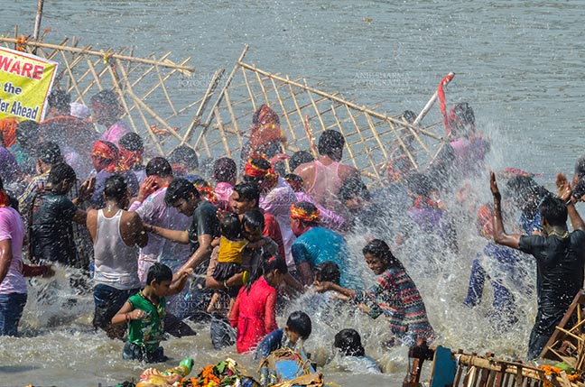 Festivals- Durga Puja Festival Durga Puja Festival, New Delhi, India-September 30, 2017: Hindu devotees taking holy dip after immersing Goddess Durga idol into river Yamuna at Kalindi Kunj, New Delhi, India. by Anil
