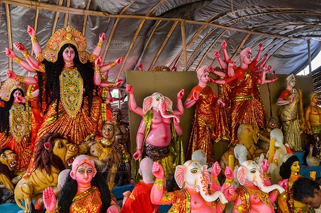 Festivals- Durga Puja Festival, Noida, India. (Photo: Anil Sharma) Durga Puja, Noida, India- September 20, 2017: A row of Hindu God Lord Ganesha and Goddess Durga in a workshop at Noida, India. by Anil