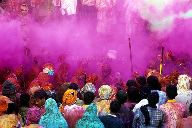 Festivals- Lathmaar Holi of Barsana (India) Lagre number of people gathered sprinkle colored powder, singing, dancing during Lathmaar Holi celebration at Barsana, Mathura, India. by Anil