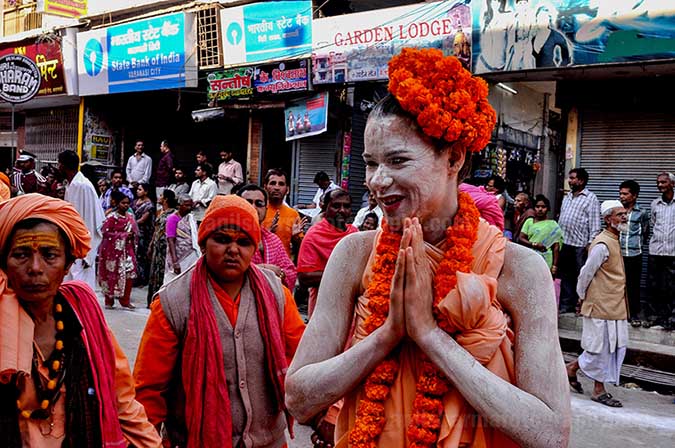 Culture- Naga Sadhu’s (India) A foreign Women Naga Sadhu greeting local people in Varanasi. by Anil