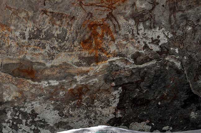 Archaeology- Bhimbetka Rock Shelters (India) Prehistoric Rock Painting- a Hunter aiming at a deer at Bhimbetka archaeological site, Raisen, Madhya Pradesh, India by Anil