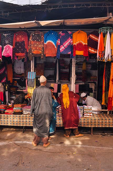 Religion- Dargah Sharif, Ajmer, Rajasthan (India) Muslim man selling “Chhador” in a shop inside the Moinuddin Chishti Mausoleum (i.e. the “Dargah Sharif”) by Anil