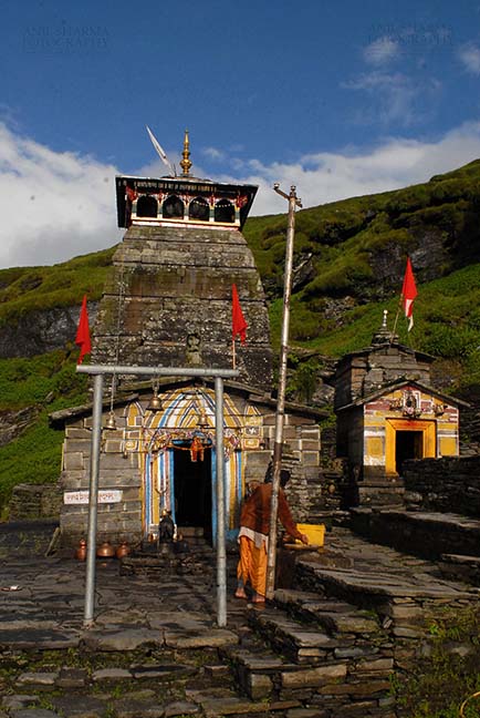 Religion- Tungnath Temple, Uttarakhand (India) Tungnath, Chopta, Uttarakhand, India- August 18, 2009: Hanging bells and red color flags at Tungnath temple complex at Tungnath, Chpota, Uttarakhand, India. by Anil