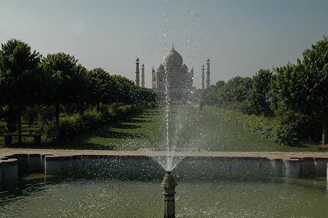 Monuments- Taj Mahal, Agra (India) Fountain at Taj Mahal complex with Taj Mahal in the background at Agra, Uttar Pradesh, India. by Anil
