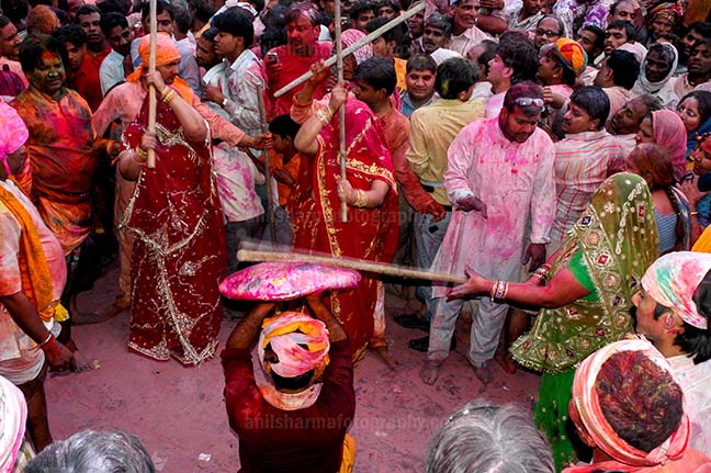 Festivals- Lathmaar Holi of Barsana (India) A man protecting himself from womens of Barsana hitting on his shield with their sticks during Lathmaar Holi at Barsana. by Anil
