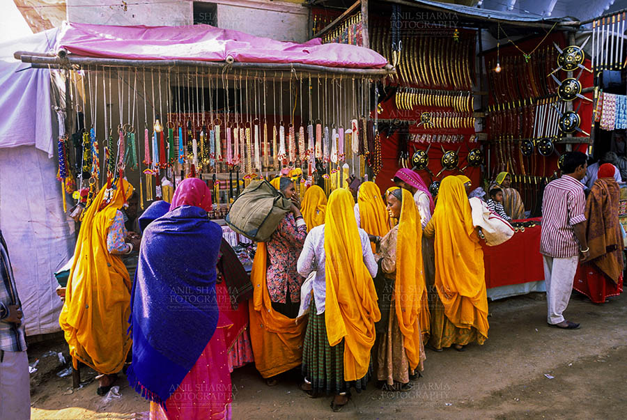 Fairs- Pushkar Fair (Rajasthan) Pushkar, Rajasthan, India- May 23, 2008: Devotees buying Bangels from a shop at Pushkar fair, Rajasthan, India. by Anil