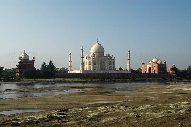 Monuments- Taj Mahal, Agra (India) The beauty of Taj Mahal (back side view) with blue sky and river yamuna flowing at Agra, Uttar Pradesh, India by Anil
