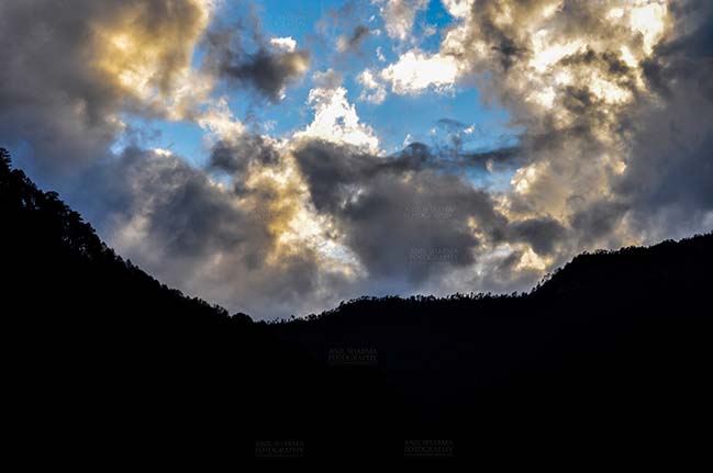 Clouds- Sky with Clouds (Uttarkashi) Clouds over Uttarkashi Hills, Uttarakhand, India-  June 17, 2013: Blue sky in the evening with light yellow and grey clouds over the hills of Uttarkashi, Uttarakhand, India. by Anil