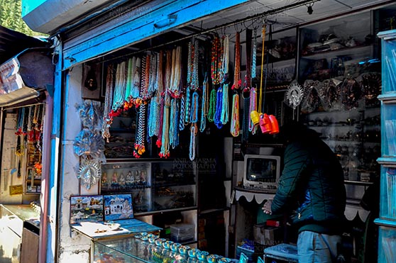 Travel- Gangotri (Uttarakhand) Gangotri, Uttarakhand, India- May 13, 2015: Shops to buy necklaces, beads, jewelry, gemstones, bracelets, earrings, bangles, and devotional objects for religious ceremonies at Gangotri Bazaar, Uttarkashi, Uttarakhand, India. by Anil